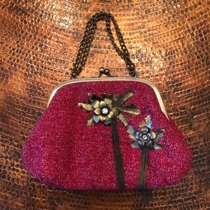 Red purse with bronze flowers